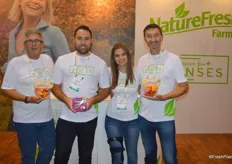 The team of NatureFresh Farms. From left to right: Ray Wowryk, Spencer Lightfoot, Kara Badder and Pete Quiring. Ray and Pete show pouch bags with organic sweet peppers while Spencer shows the TOMZ snacking tomatoes.